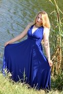 blonde in a blue dress near the water
