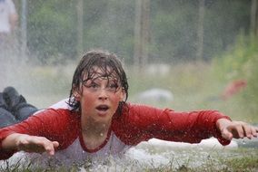 child in water after rain