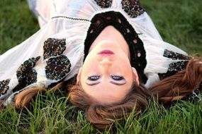 model with blue eyes on the green grass