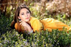 model in yellow dress on the meadow