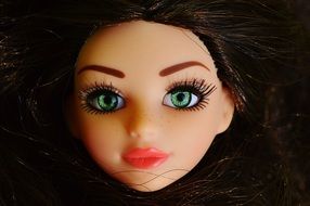 head doll with brown hair and green eyes