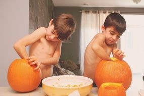 children with pumpkins as preparation for halloween