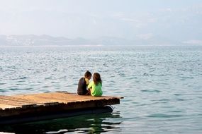 children on the pier near the water