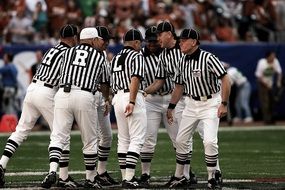 Team of American Football Referee on field