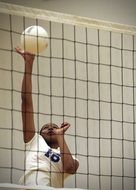 the player with the ball near volleyball net