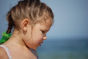 girl with braided hair on the beach