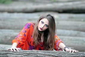 dark blond model posing among timbers
