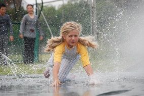 little girl in the water after rain