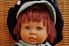 head doll wearing a hat close up