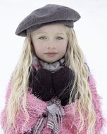 young girl in a warm pink cape