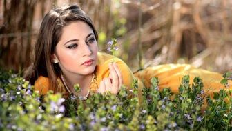 beautiful girl lies on a flower glade