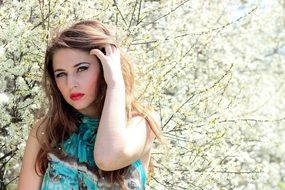 young beautiful woman in the flowering garden