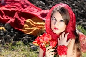 Portrait of beautiful woman with red tulips in hands