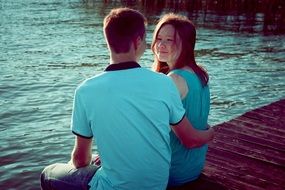 guy and girl on the shore of the pond