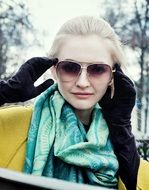 girl in glasses and black gloves in the park