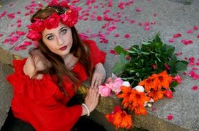 girl in red among rose petals