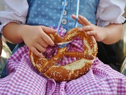 Breze, German Pretzel in Child Girl hands