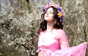 girl among the flowers in spring