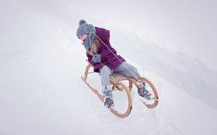 girl on sledge climbs down