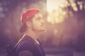 portrait of a man with a beard and a red baseball cap