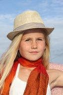 portrait of a blonde in an orange scarf