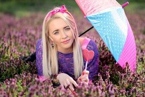 girl with an umbrella on a flower meadow