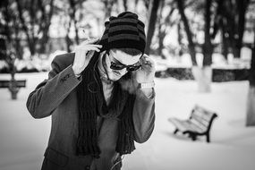 black and white photo of a young man in a park in winter