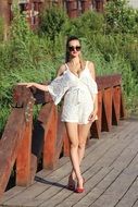 fashionable girl on a wooden bridge