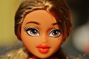 doll's face with brown eyes and dark skin close-up