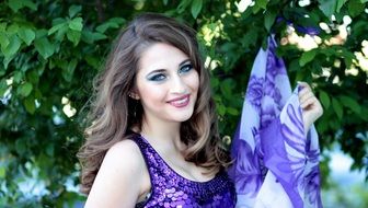 portrait of a girl with blue eyes and purple scarf