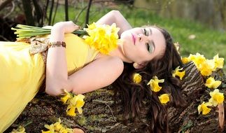 girl with daffodils on a tree