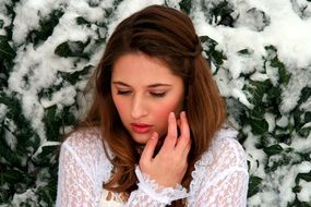 Portrait of the girl near the tree in winter