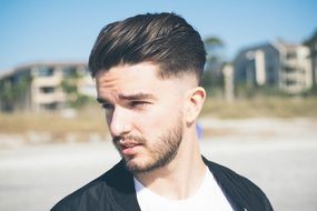 photo portrait of young man model on a resort beach