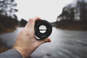 camera lens in the hands of a man