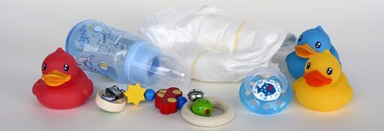 Toy Ducks, Baby Bottle and Diapers