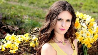 beautiful girl with yellow daffodils