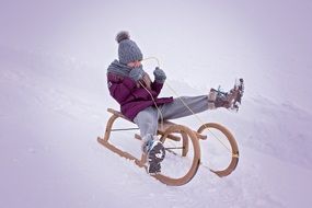 Girl on wooden sledge