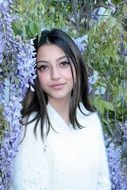 young Girl with Brown Eyes among Flowers