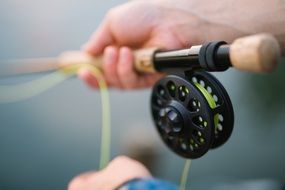 telescopic fishing rod in human hands