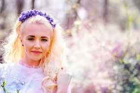 blonde with blue eyes in the spring garden
