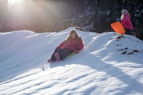 children on sleds in the winter