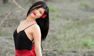 brunette with a red flower in black hair