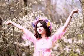 model in pink dress with floral wreath