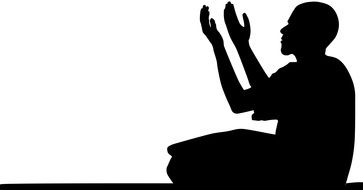 dark silhouette of a man in prayer