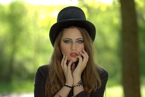 thoughtful girl in a black hat