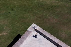 panoramic view of tourists on a stone wall