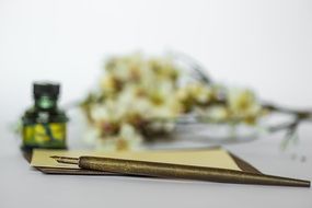 vintage still life with pen, paper, flowers and Ink in bottle