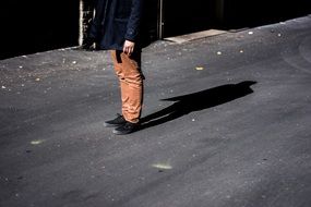 shadow of a young man on the pavement