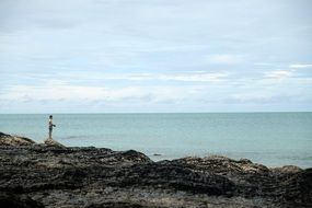 man fishing in the ocean