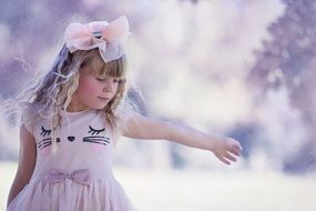 photo of a girl with a bow on a background of a winter landscape